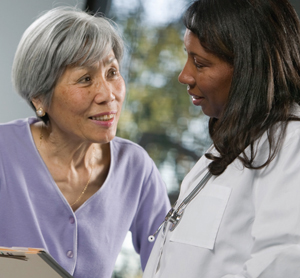 Woman talking with health care provider.